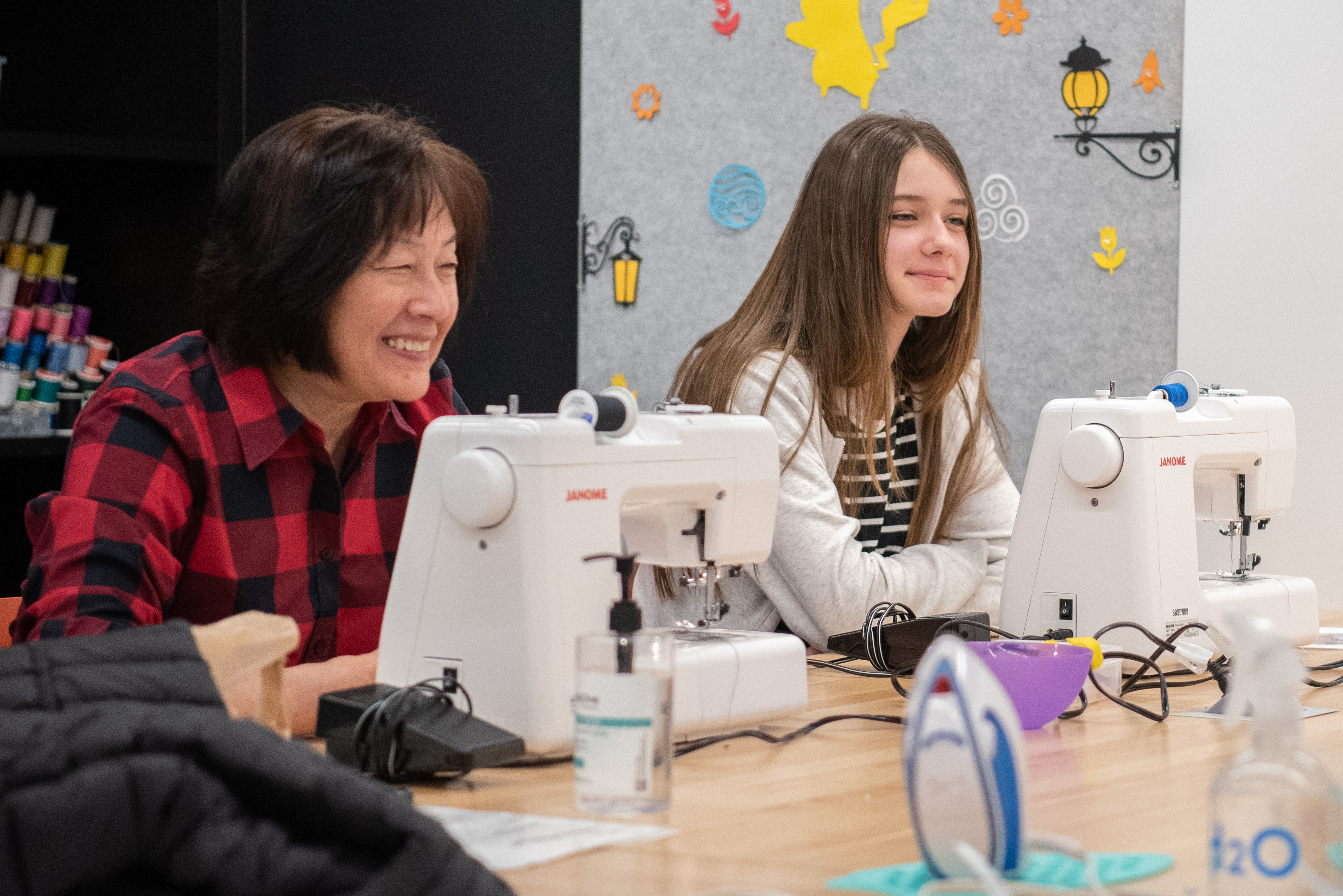 Two patrons learning how to sew at the library